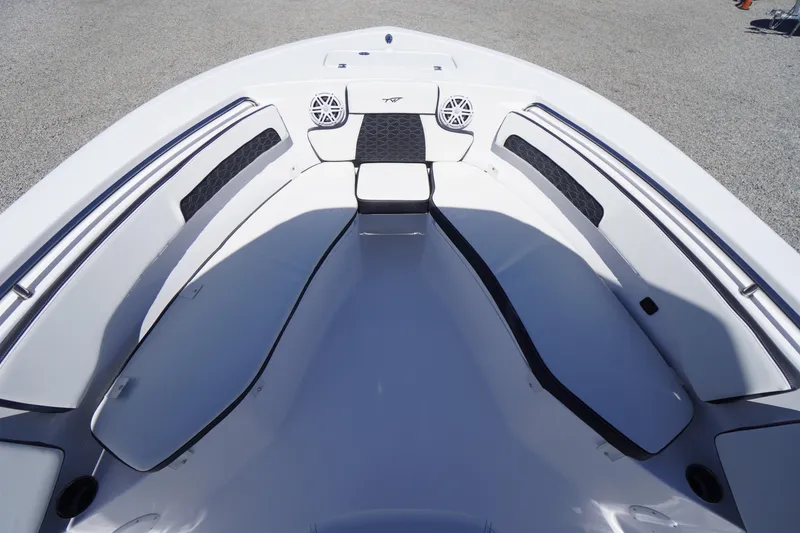 Slide: The Image of 2026 Tidewater 220 CC Adventure boat interior with cushioned seating and speakers. - 7