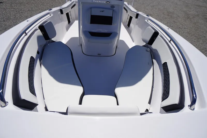 Slide: The Image of 2026 Tidewater 220 CC Adventure boat interior with white cushioned seating. - 8