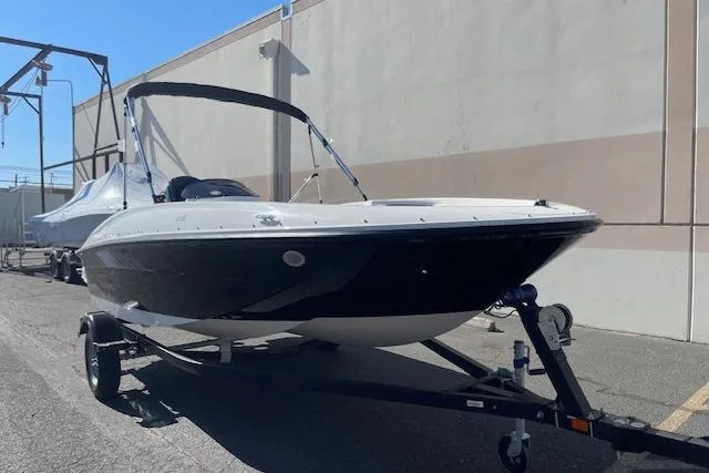 Slide: The Image of 2026 Bayliner Element E16 boat on trailer, parked outdoors. - 1