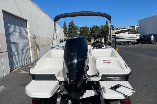 Slide: The Image of 2026 Bayliner Element E16 boat with outboard motor, parked outdoors on a sunny day. - 4