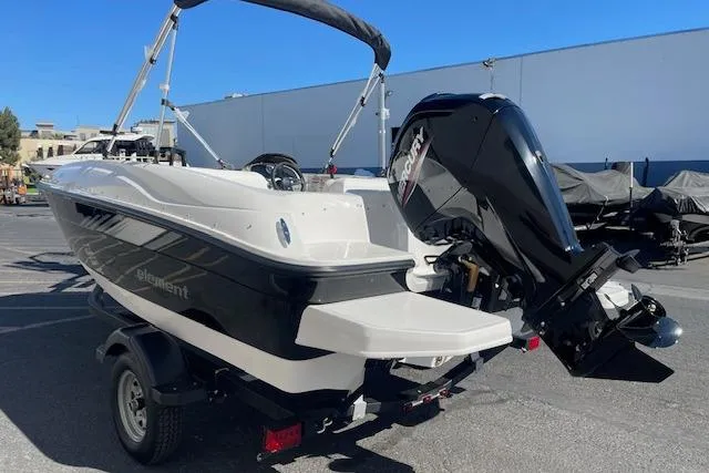 Slide: The Image of 2026 Bayliner Element E16 boat with outboard motor, parked on a trailer. - 5