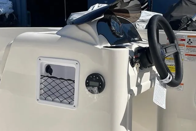 Slide: The Image of 2026 Bayliner Element E16 boat dashboard with steering wheel and instrument panel. - 6