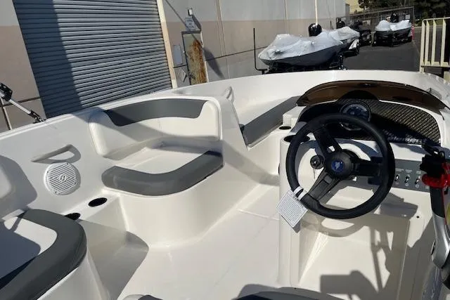 Slide: The Image of 2026 Bayliner Element E16 boat interior with steering wheel and seating. - 7
