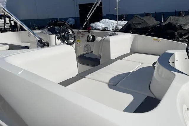 Slide: The Image of 2026 Bayliner Element E16 boat interior with white seating and steering wheel. - 9