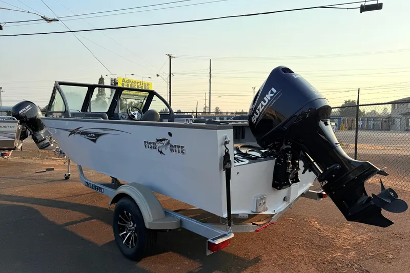 Slide: The Image of 2026 Fish Rite Sportsman 20 boat on trailer, parked outdoors. - 3