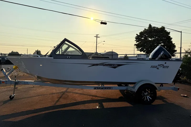 Slide: The Image of 2026 Fish Rite Sportsman 20 boat on trailer, parked outdoors near a building. - 4