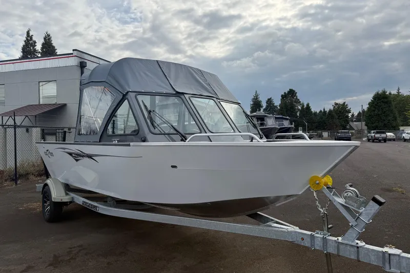 Slide: The Image of 2026 Fish Rite Sportsman 20 boat on trailer, featuring Suzuki outboard motor. - 6