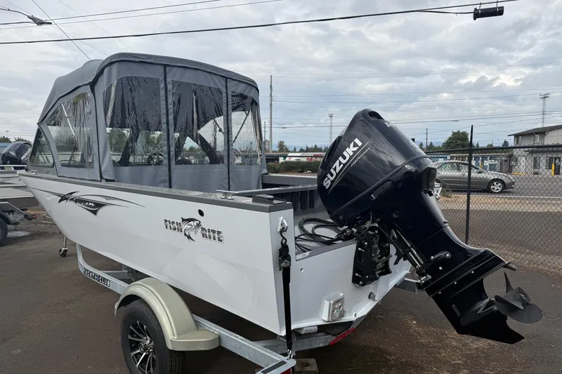 Slide: The Image of 2026 Fish Rite Sportsman 20 boat with Suzuki outboard motor, parked on a trailer. - 8