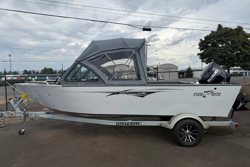 Slide: The Image of 2026 Fish Rite Sportsman 20 boat on trailer with Suzuki outboard motor. - 9