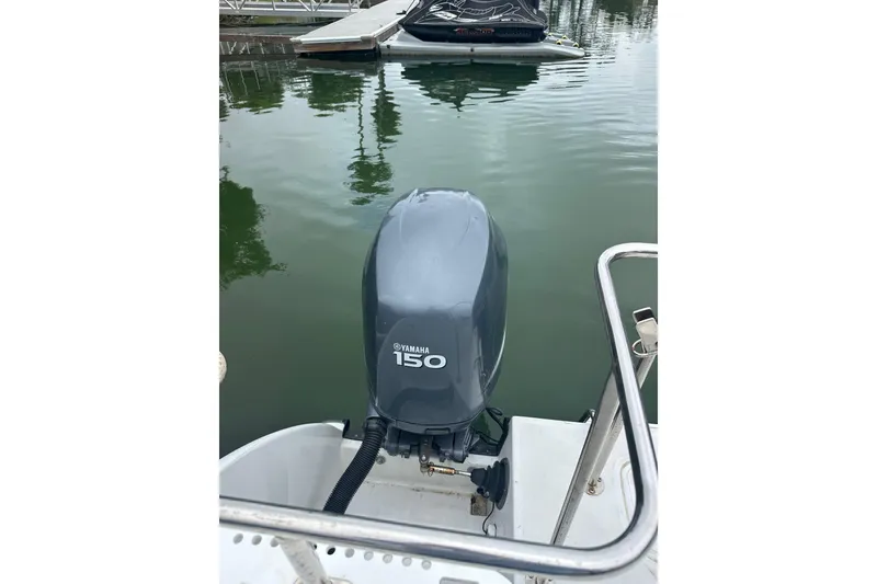 Slide: The Image of 2005 Glacier Bay 2680 Coastal Runner with Yamaha 150 outboard motor at dock. - 12