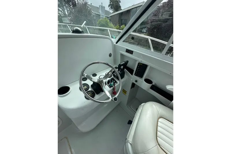 Slide: The Image of 2005 Glacier Bay 2680 Coastal Runner boat helm with steering wheel and controls. - 17