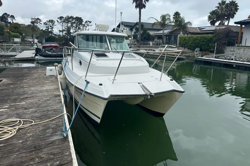 Slide: The Image of 2005 Glacier Bay 2680 Coastal Runner boat docked in a serene marina setting. - 2