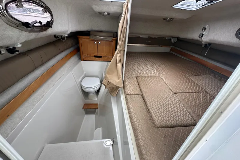 Slide: The Image of 2005 Glacier Bay 2680 Coastal Runner cabin interior with bed and compact bathroom. - 20