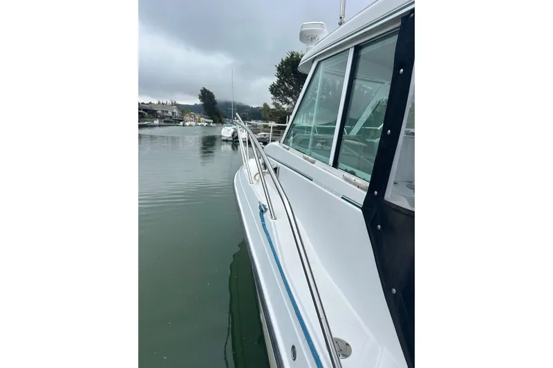 Slide: The Image of 2005 Glacier Bay 2680 Coastal Runner boat docked on calm water. - 21