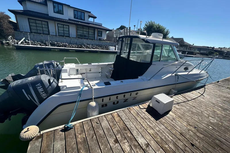 Slide: The Image of 2005 Glacier Bay 2680 Coastal Runner boat docked with twin Yamaha engines. - 3
