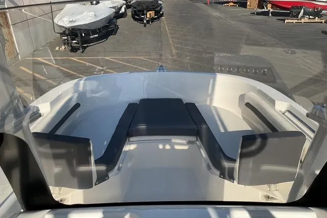 Slide: The Image of 2026 Bayliner Trophy T22CC boat on trailer, white exterior, parked outdoors. - 10