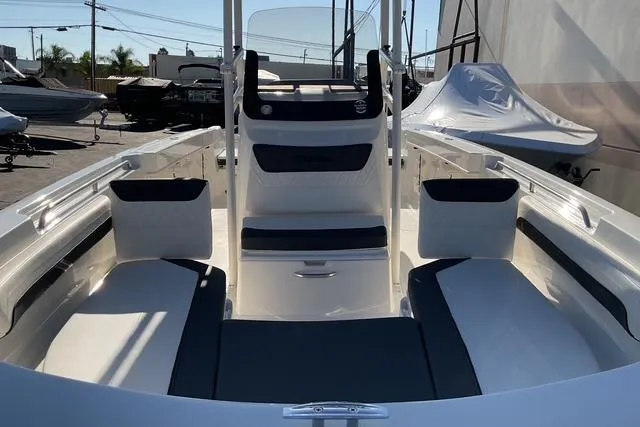 Slide: The Image of 2026 Bayliner Trophy T22CC boat interior with dual seats and outboard motor. - 12