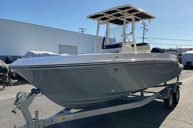 Slide: The Image of 2026 Bayliner Trophy T22CC boat stern with motor and rod holders. - 13