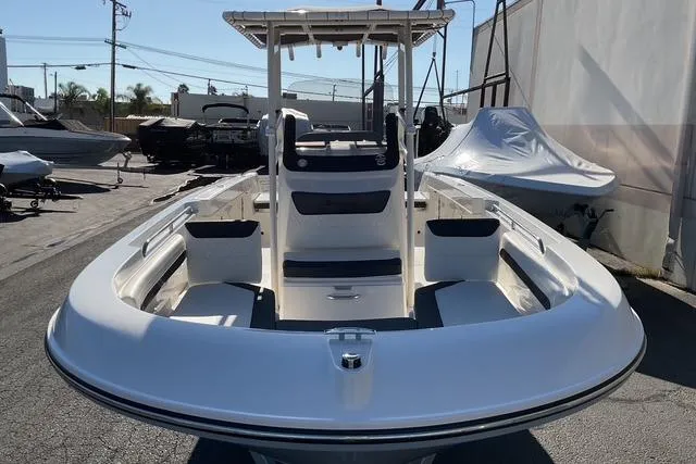 Slide: The Image of 2026 Bayliner Trophy T22CC boat interior with steering console and seating. - 17