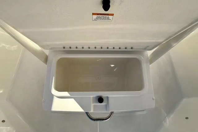 Slide: The Image of 2026 Bayliner Trophy T22CC boat storage compartment, open and empty. - 18