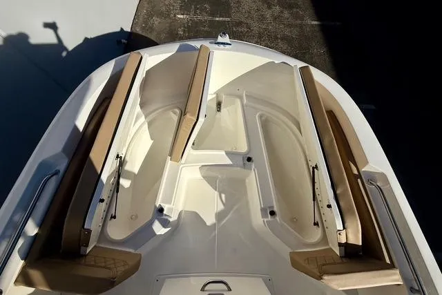 Slide: The Image of 2026 Bayliner Trophy T22CC boat interior with tan seating and spacious layout. - 19