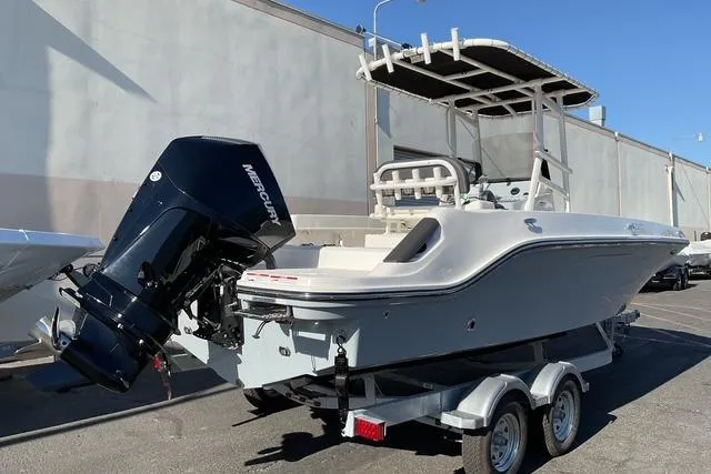Slide: The Image of 2026 Bayliner Trophy T22CC boat on trailer, featuring Mercury outboard engine. - 2