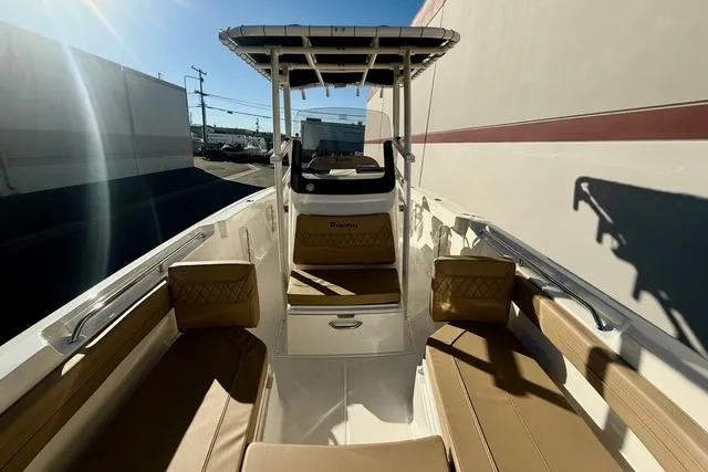 Slide: The Image of 2026 Bayliner Trophy T22CC boat interior with tan seating and center console. - 20