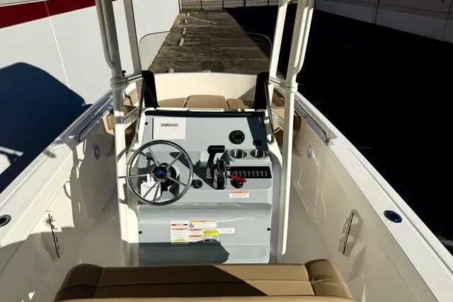 Slide: The Image of 2026 Bayliner Trophy T22CC boat cockpit with steering wheel and controls. - 22