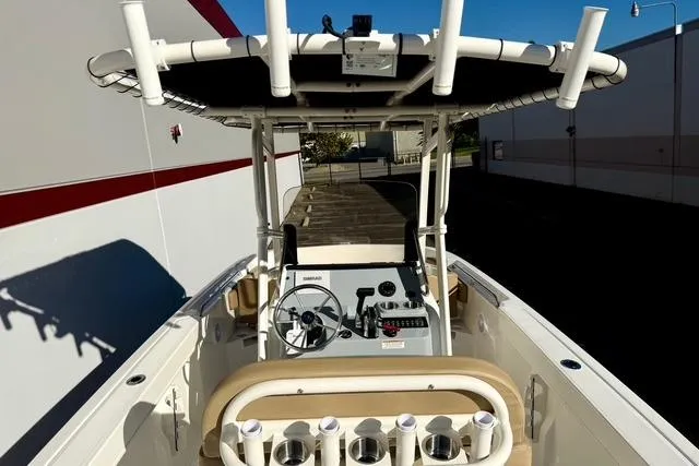 Slide: The Image of 2026 Bayliner Trophy T22CC boat interior with steering console and rod holders. - 25