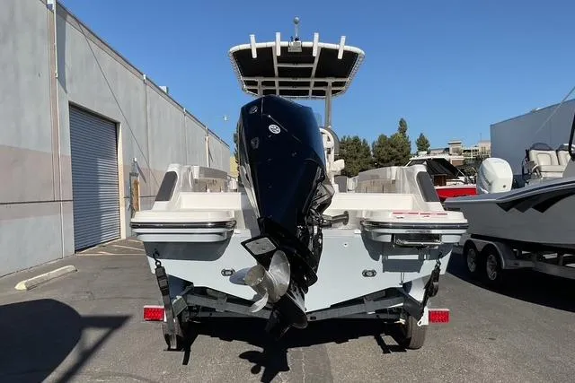 Slide: The Image of 2026 Bayliner Trophy T22CC boat with powerful outboard motor, parked outdoors. - 3