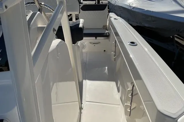 Slide: The Image of 2026 Bayliner Trophy T22CC boat on trailer, parked outdoors, side view. - 6