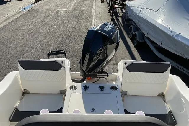 Slide: The Image of 2026 Bayliner Trophy T22CC boat on trailer, parked outdoors. - 8