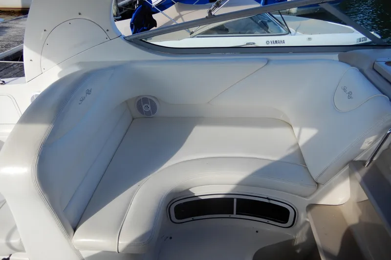 Slide: The Image of 2004 Sea Ray 280 Sundancer boat interior with white leather seating. - 11