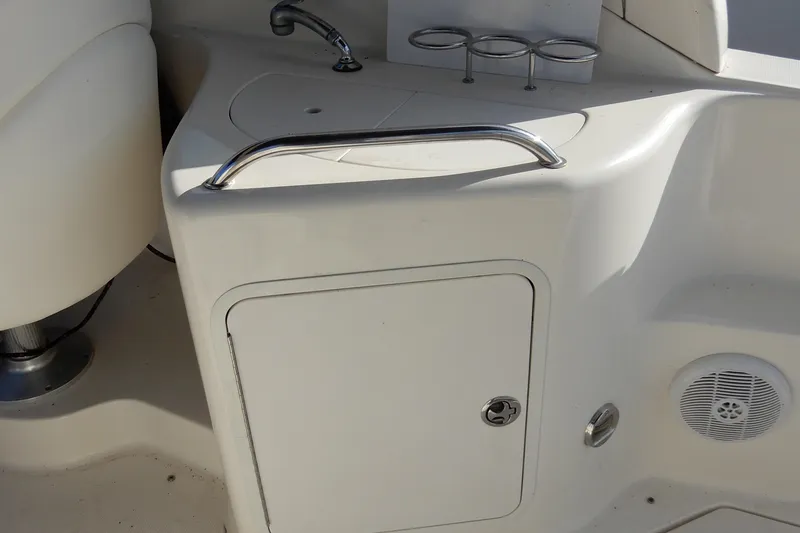 Slide: The Image of 2004 Sea Ray 280 Sundancer boat interior with sink and storage compartment. - 12