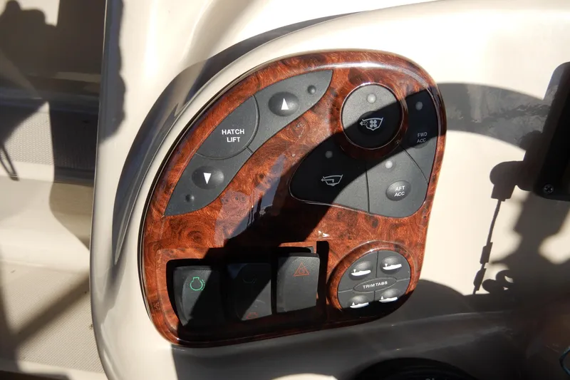 Slide: The Image of Control panel of a 2004 Sea Ray 280 Sundancer boat with wood finish. - 16