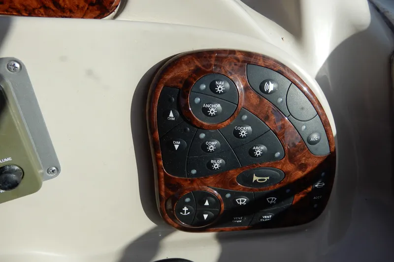 Slide: The Image of Control panel of a 2004 Sea Ray 280 Sundancer boat with woodgrain finish. - 17