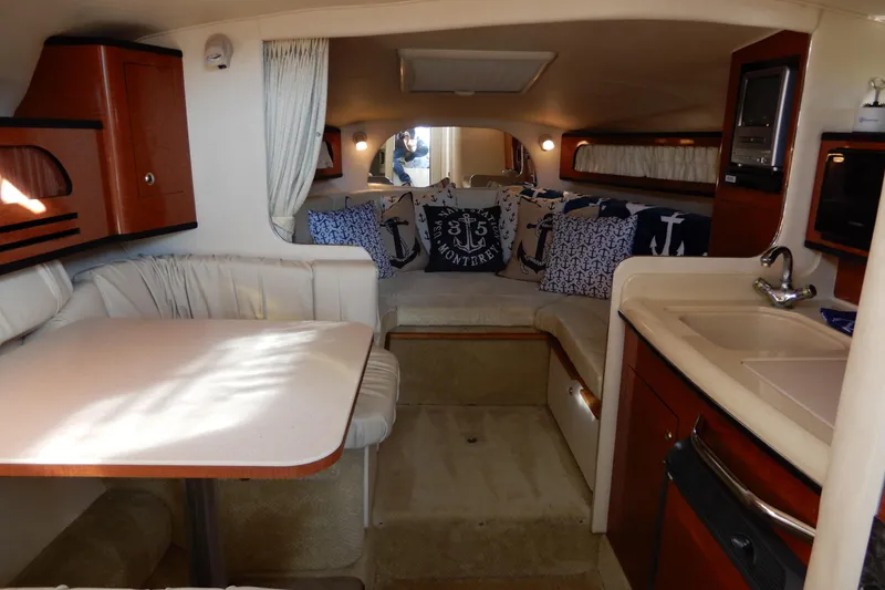 Slide: The Image of Interior of 2004 Sea Ray 280 Sundancer boat with cozy seating and nautical decor. - 22
