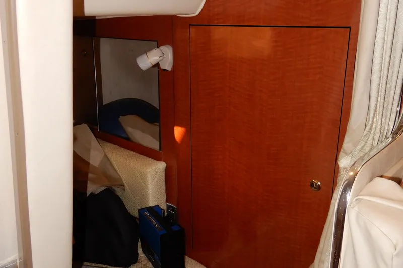 Slide: The Image of Interior cabin of 2004 Sea Ray 280 Sundancer with wood paneling and seating area. - 32