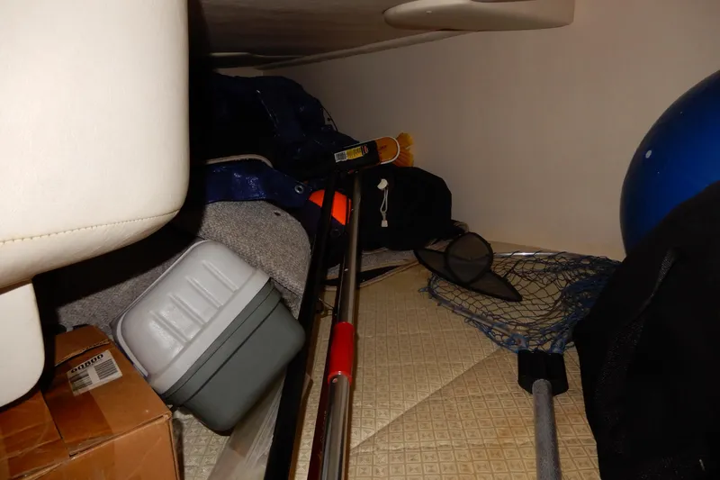 Slide: The Image of Storage area in a 2004 Sea Ray 280 Sundancer with fishing gear and equipment. - 33