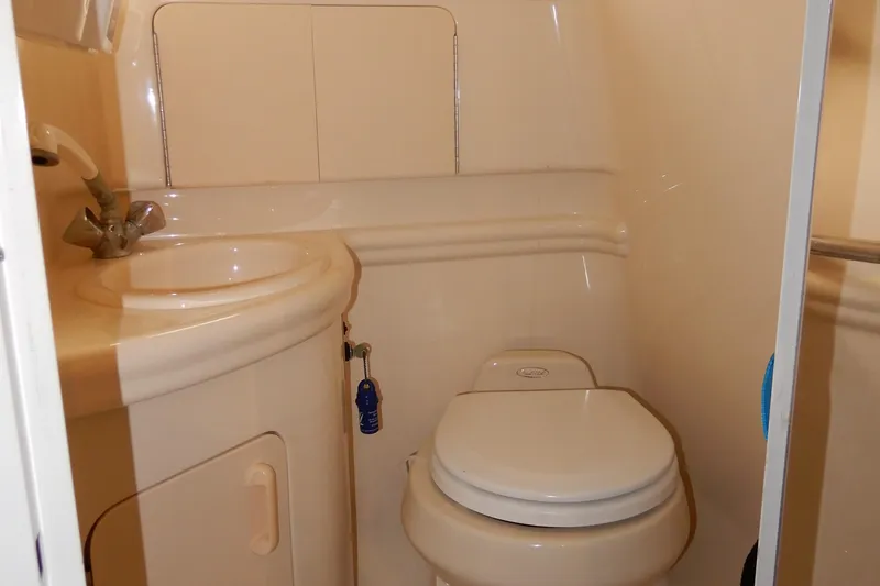 Slide: The Image of 2004 Sea Ray 280 Sundancer bathroom with compact sink and toilet. - 34