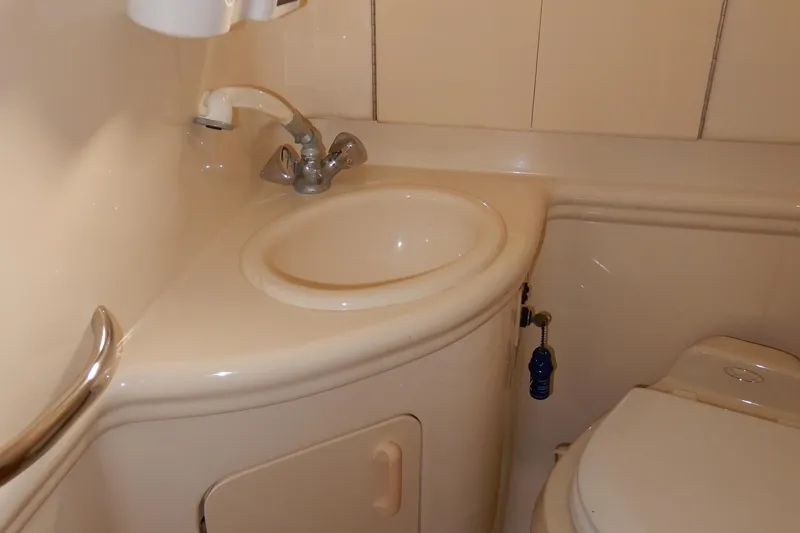 Slide: The Image of Compact bathroom in 2004 Sea Ray 280 Sundancer boat with sink and toilet. - 35