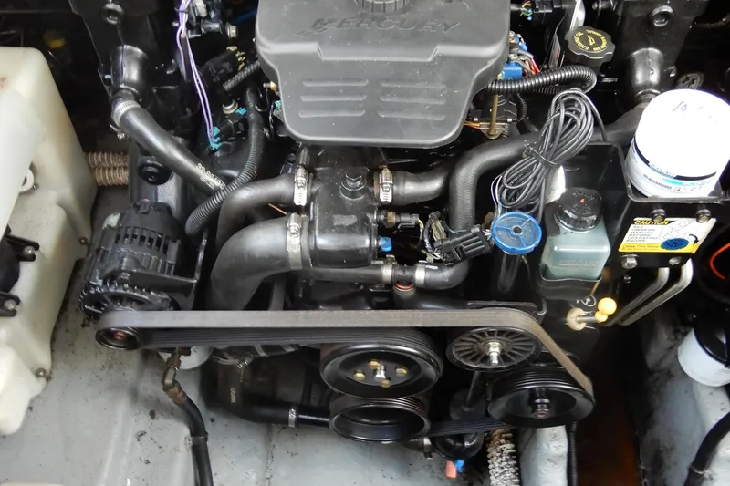 Slide: The Image of Engine compartment of a 2004 Sea Ray 280 Sundancer boat, showcasing mechanical components. - 39