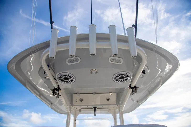 Slide: The Image of 2023 Cobia 280 Center Console boat top view with rod holders and speakers. - 11