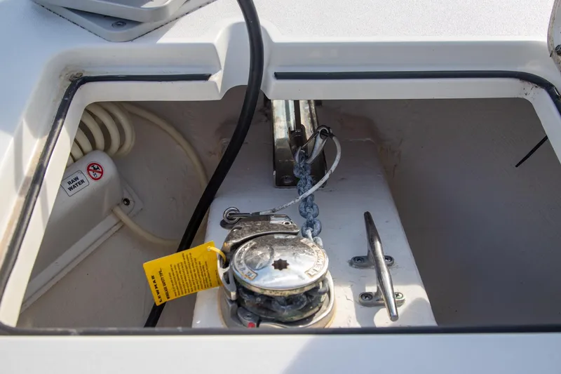 Slide: The Image of Anchor compartment of 2023 Cobia 280 Center Console boat with chain and winch. - 12