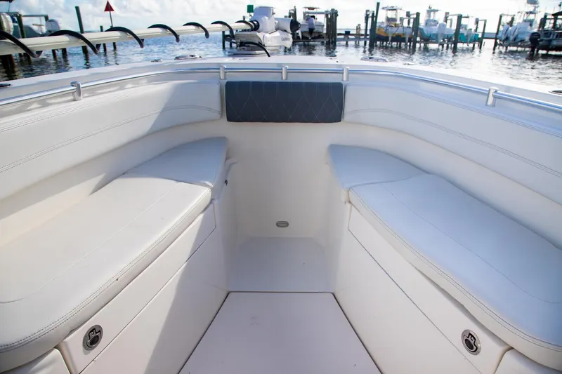 Slide: The Image of 2023 Cobia 280 Center Console boat interior with white cushioned seating. - 13