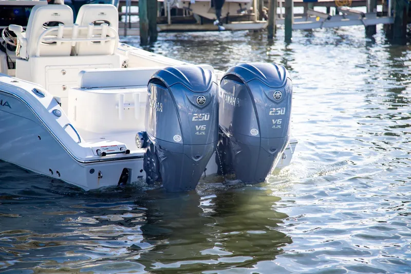 Slide: The Image of 2023 Cobia 280 Center Console with twin Yamaha 250 V6 outboard engines in water. - 17