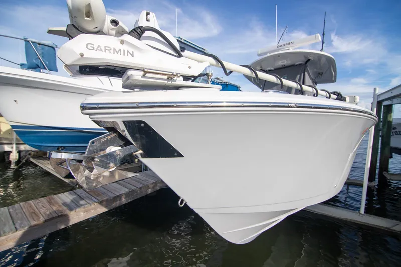 Slide: The Image of 2023 Cobia 280 Center Console boat docked with Garmin equipment. - 22