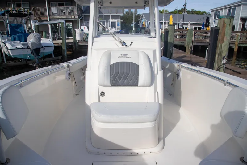 Slide: The Image of 2023 Cobia 280 Center Console boat interior at a marina dock. - 29