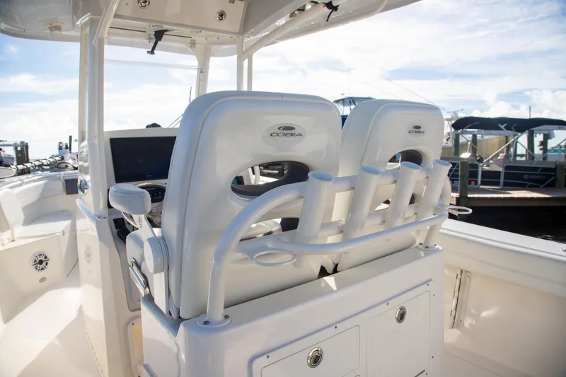 Slide: The Image of 2023 Cobia 280 Center Console boat interior with dual seats and rod holders. - 6