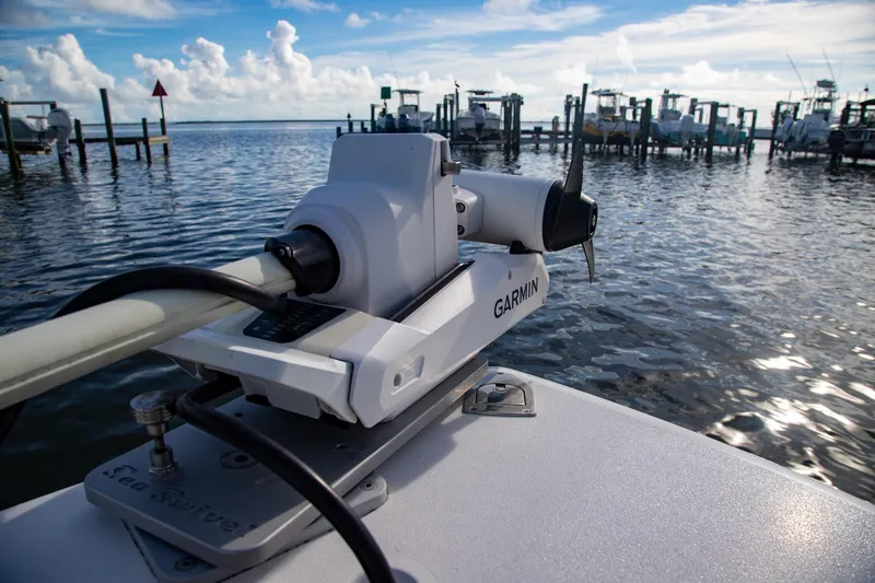 Slide: The Image of 2023 Cobia 280 Center Console with Garmin equipment at a marina dock. - 8